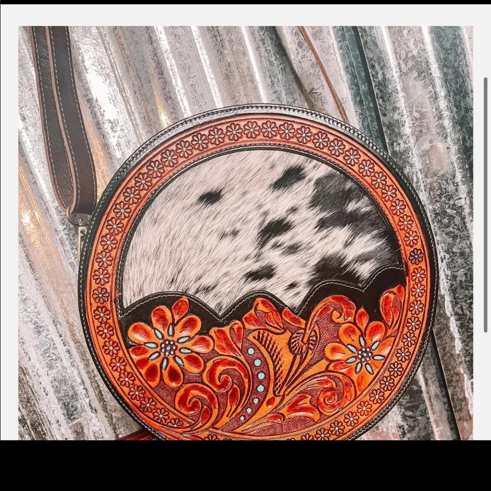 Cowhide and tooled leather canteen purse.